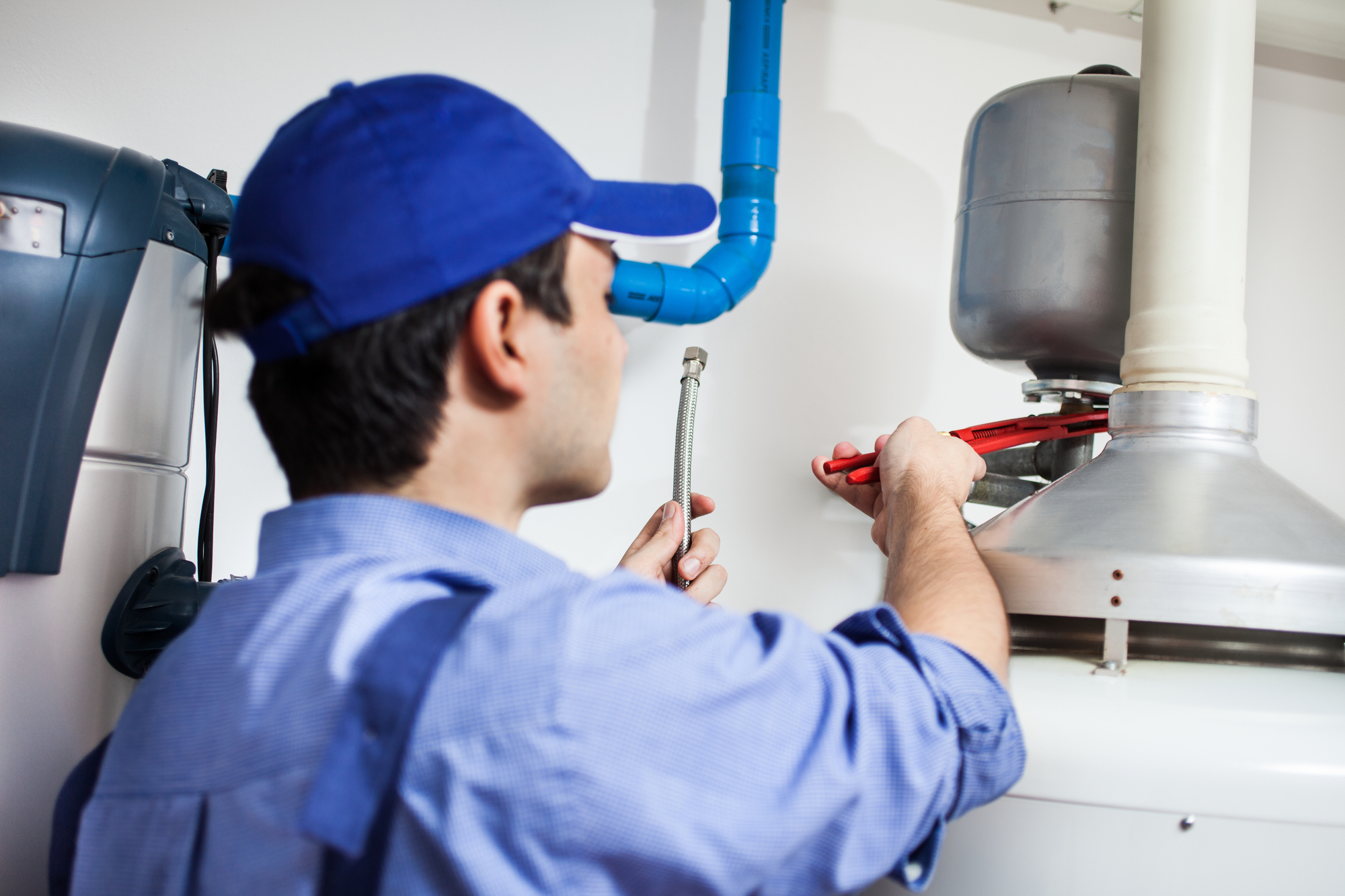 Technician Repairing a Hot-water Heater