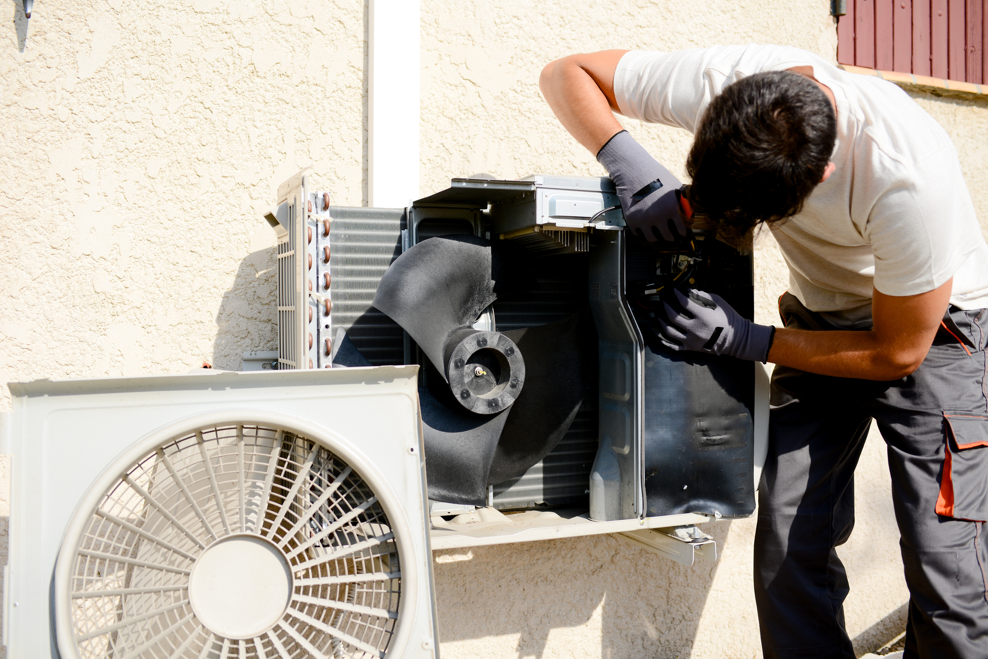 Worker Installing Outdoor Compressor Unit Air Conditioner