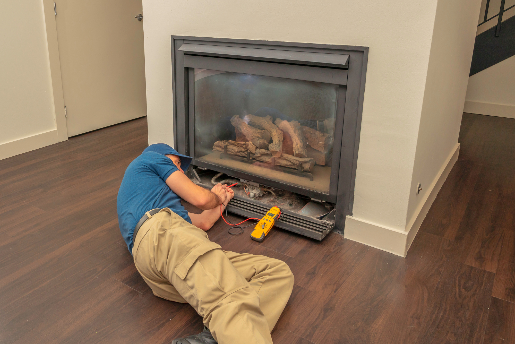 Service Technician Working On A Gas Fireplace